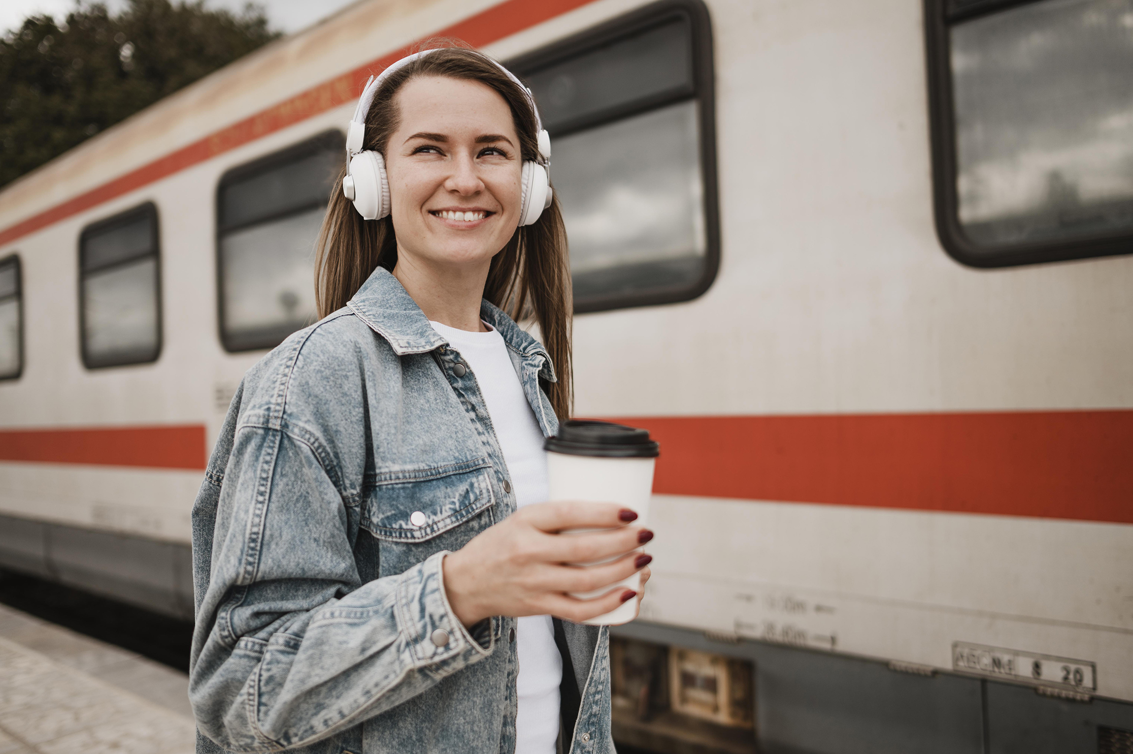 Woman listening music train platform
