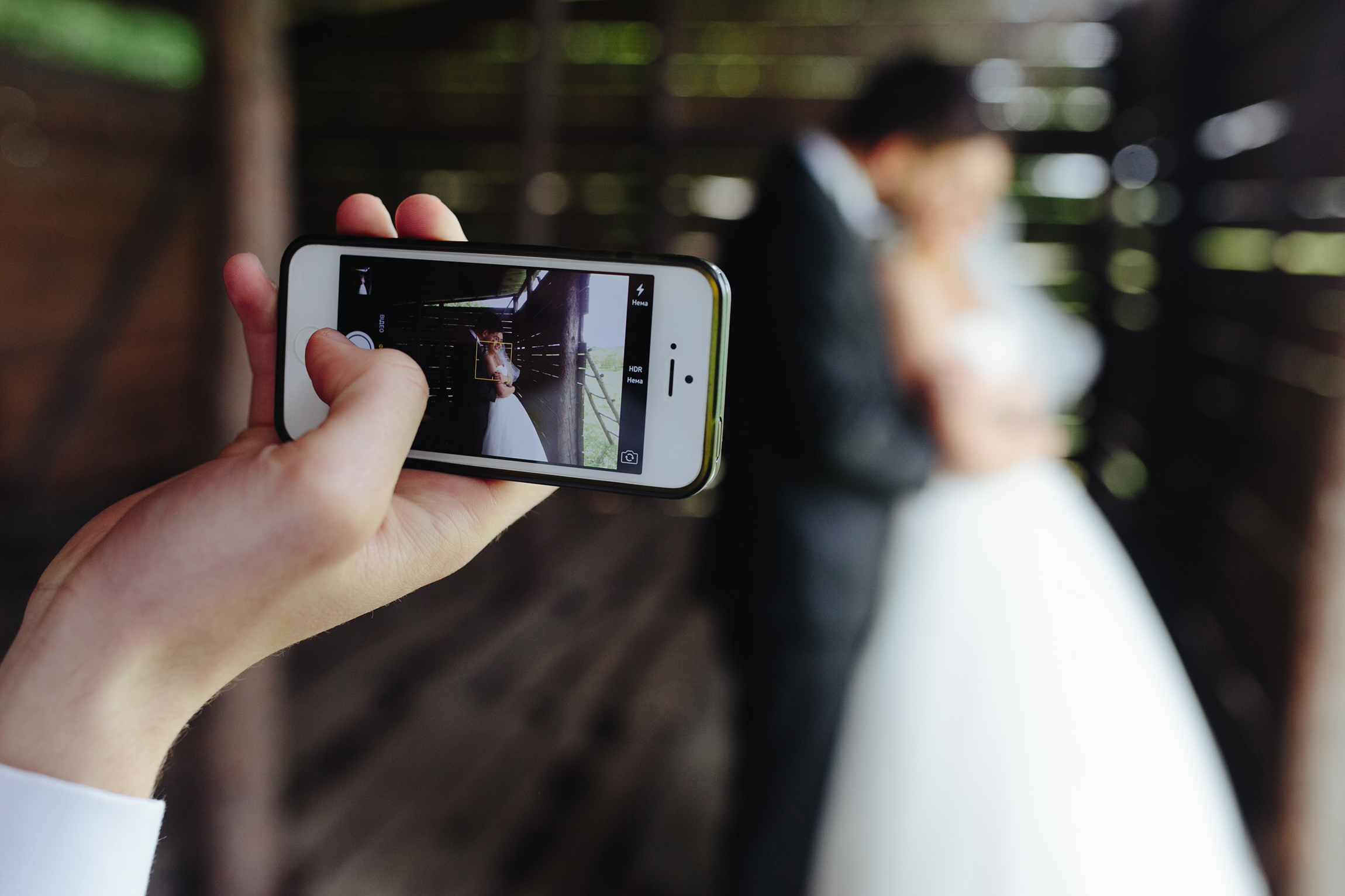 Close up mobile taking photo newlyweds
